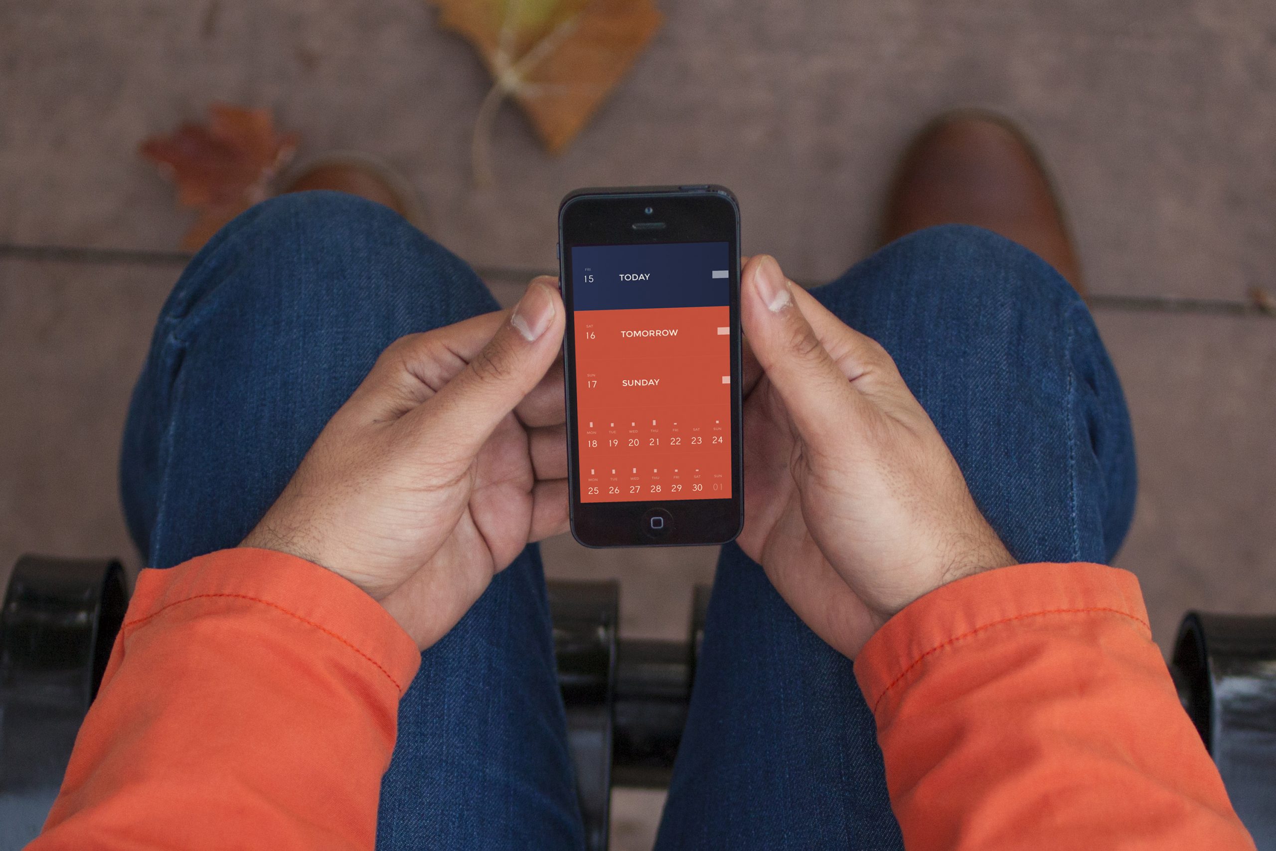 Person holding a phone showing the Peek Calendar today and tomorrow view